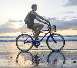 cyclist on the beach at low tide on the Nicoya Peninsula in Costa Rica