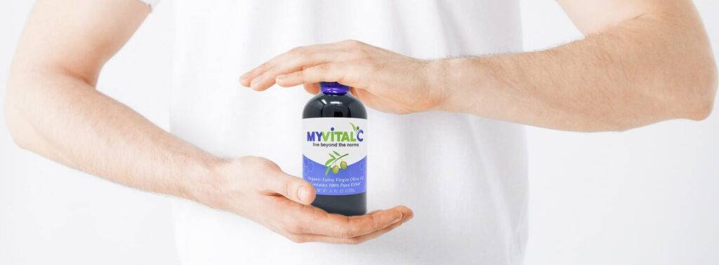 MyVitalC Olive Oil Bottle between 2 hands