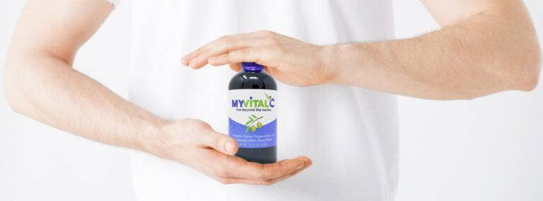 MyVitalC Olive Oil Bottle between 2 hands