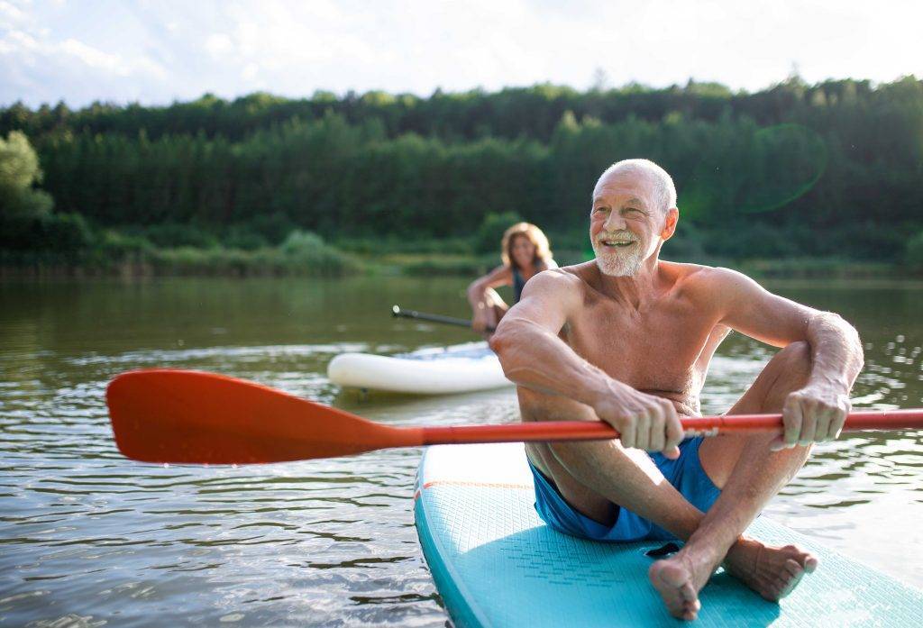 older couple on a lake enjoying long life