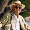 older japanese gentleman sitting by the sea in Okinawa, a longevity blue zone area